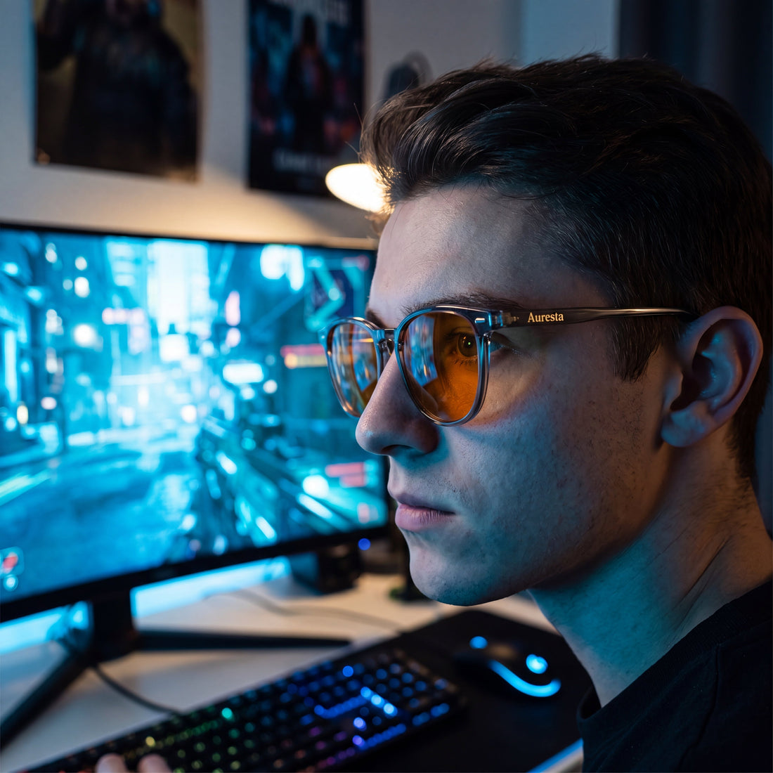 Gamer wearing Auresta Aura blue light glasses with amber lenses at a gaming setup