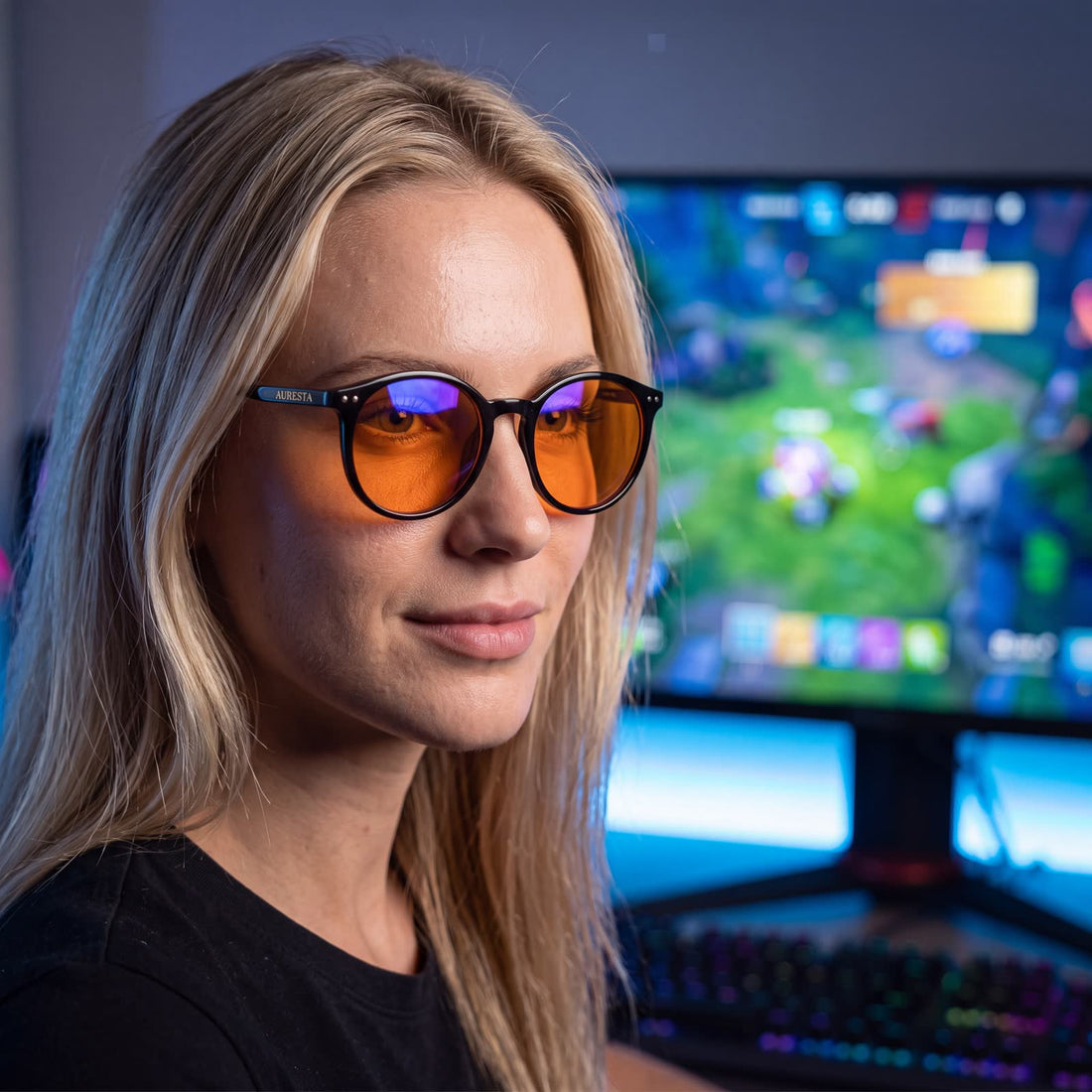 Auresta Raven amber-lens glasses beside a laptop in a home office